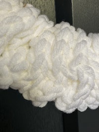 a close up of a white crocheted towel