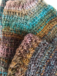 a close up of a pair of knitted mittens