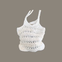 a white crocheted bag on a gray background