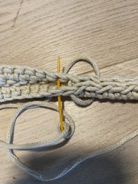 a crocheted knot with a yellow thread