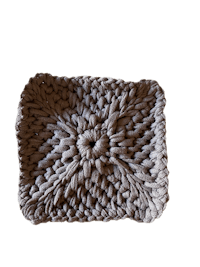 a crocheted dishcloth on a black background