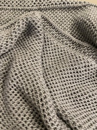 a close up of a grey knitted blanket