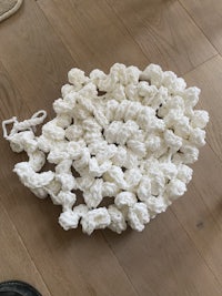 a white crocheted rug on a wooden floor