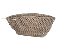 a beige crocheted bag with a wooden handle