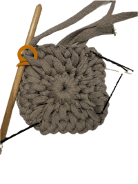 a crocheted piece of yarn and a crochet hook