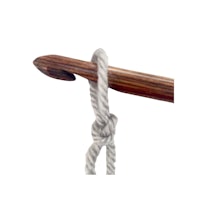 a wooden knitting needle with a rope attached to it