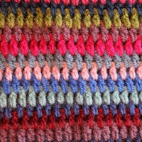 a close up of a colorful crocheted stitch