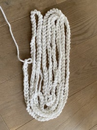 a white crocheted rope on a wooden floor